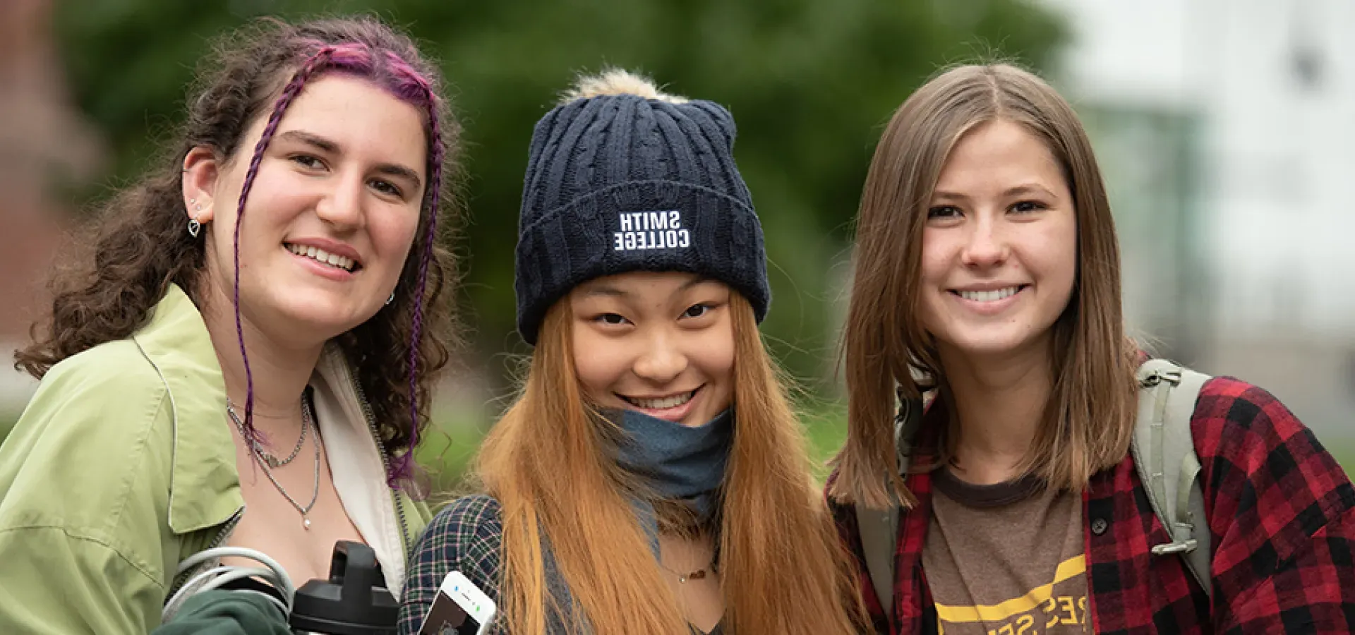 Three students smiling