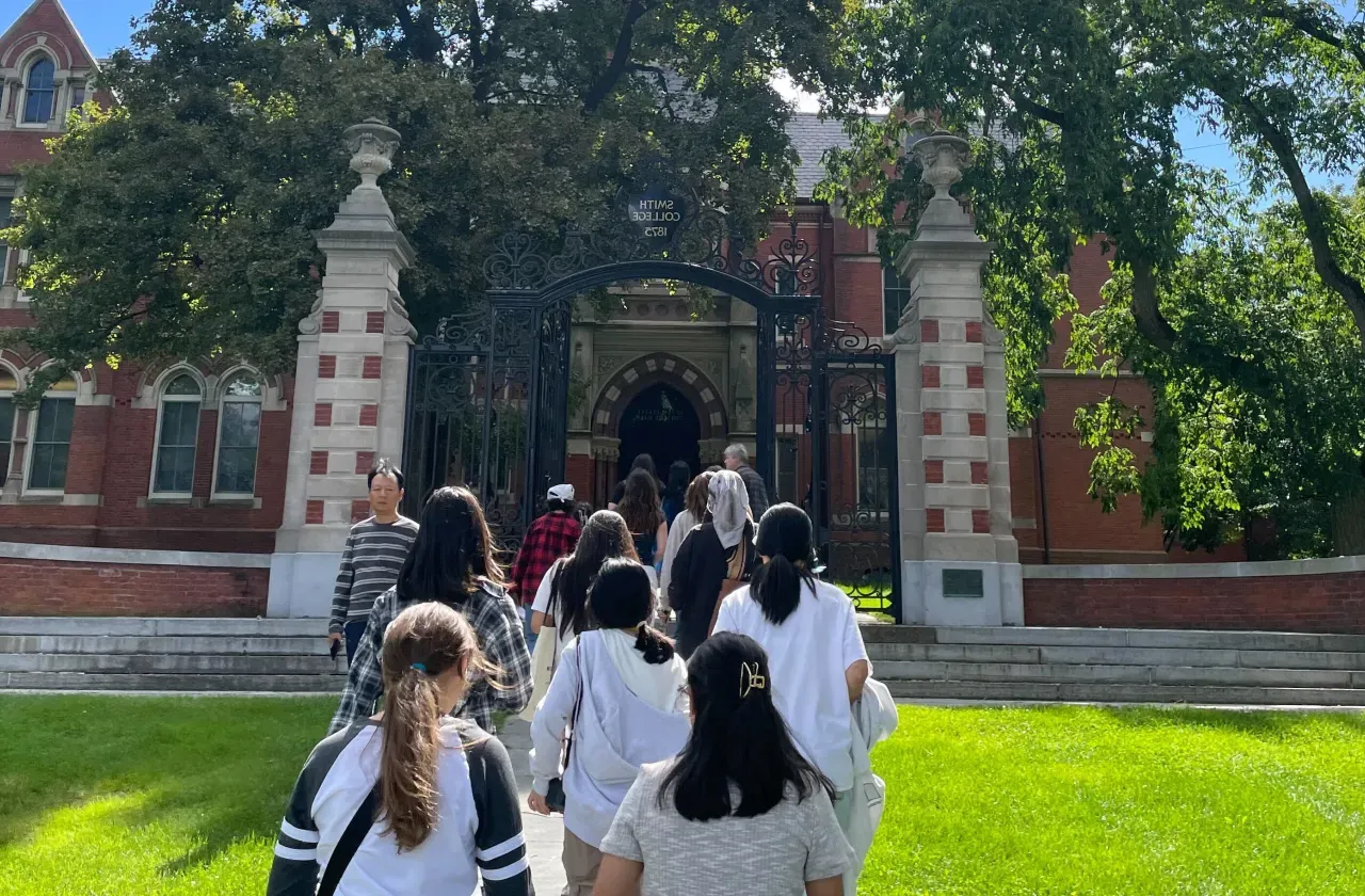 Students walking toward the Grecourt Gates.