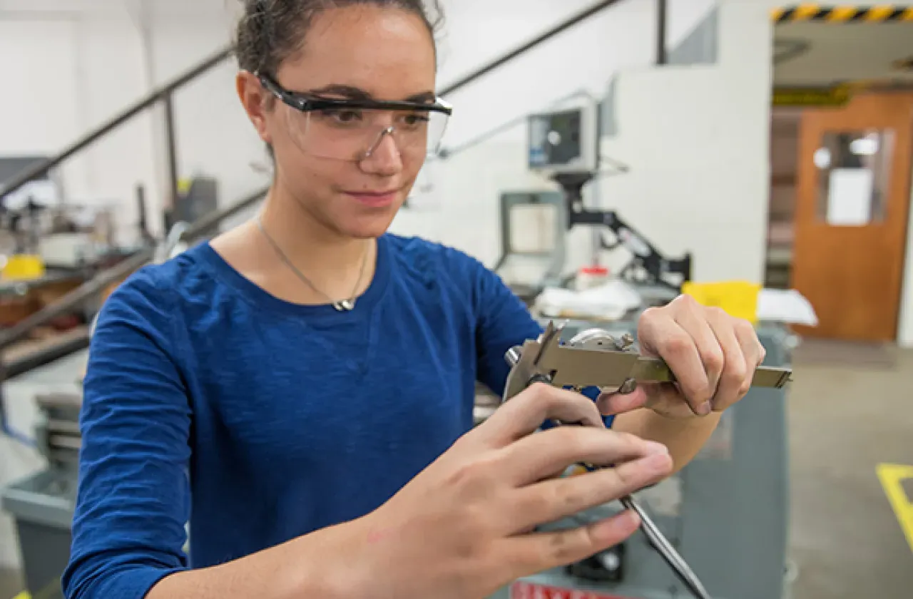 Photo of a student working in design and fabrication