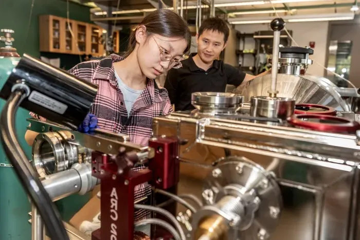 A student and a supervisor in a lab.